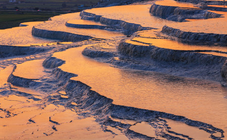 Travertine pools and terraces in Pamukkale, Turkey in sunset timeの写真素材