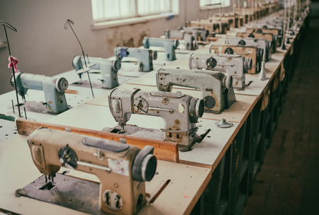 Old sewing machines at an abandoned garment factoryの写真素材
