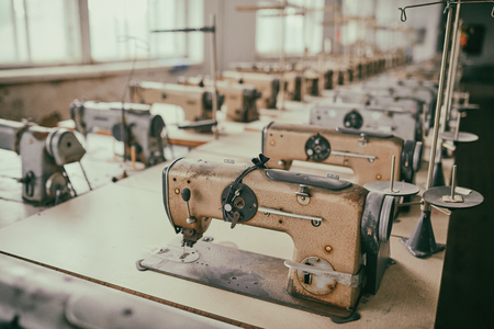 Old sewing machines at an abandoned garment factoryの写真素材