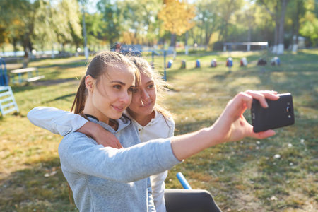 Beautiful girls taking a selfie with a smart phone.の写真素材