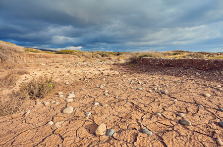 global warming. deep blue sky with clouds over drought earthの写真素材