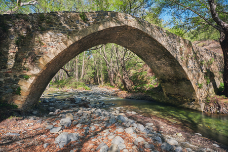 medieval Venetian bridge in Cyprus in summer forestの写真素材