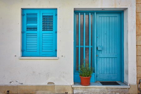 Typical exterior of Greek traditional town street with colorful buildings and marine blue door on Kastelorizo Island, Dodecanese, Greece, Europeの写真素材