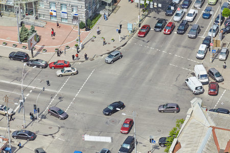 aerial view of cars and people, busy traffic in big intersection.