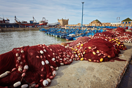 Fishing boats, gear and catch on background of Castelo Real of Mogador. Essaouira, Moroccoの写真素材