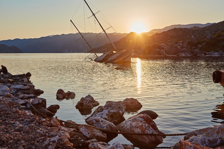 The ship sank in the bay in shallow water in Kekovo, Turkey. Picture at sunset.の写真素材