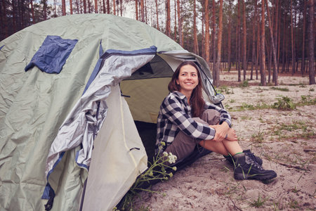 A girl hiker in a tent mountainsの写真素材