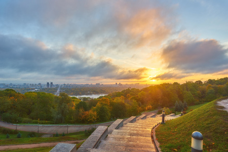 dramatic cloudy blue sky over the green park in Kyiv. Landscape shot. Park of Eternal Glory, Kiev.の写真素材