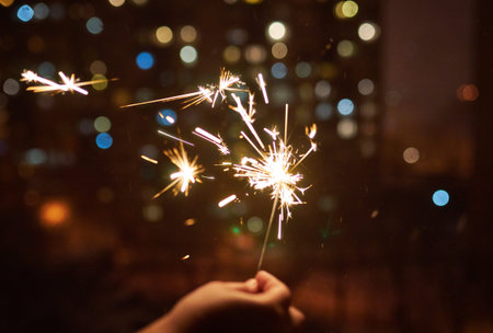 bright festive Christmas and happy new year sparkler in handの写真素材