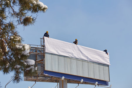 Worker prepares billboard to installing new advertisement.の写真素材