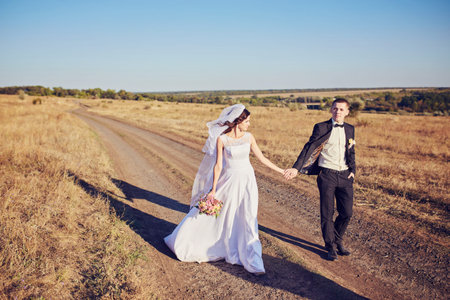 Young wedding couple enjoying romantic moments outside on a summer meadowの写真素材