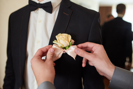 Hands of wedding groom getting ready in suitの写真素材