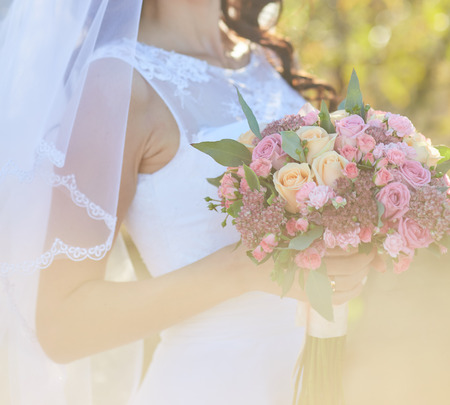 Beautiful wedding bouquet in hands of the brideの写真素材