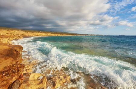 Storming sea and wide-spreading waves, Cyprus coastline.の写真素材