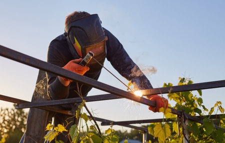 Worker welder working welding steel in industry with safety mask safety gloves and safety equipment....
