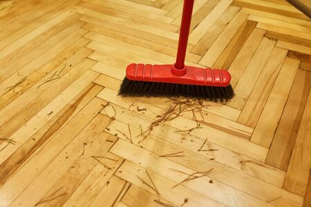 Cleaning after the celebration of Christmas. Broom and scoop with needles from a Christmas treeの写真素材