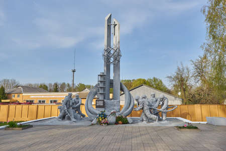 Ukraine, Chernobyl, April 25 2019:. Monument to the liquidators of the Chernobyl disaster at the FES. Fireman in a protective helmet with a fire hoseのeditorial素材