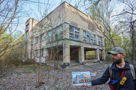 Pripyat, Ukraine - April 25 2019: Destroyed building and photo as it was before the Chernobyl disaster. Pripyat, exclusion zoneのeditorial素材
