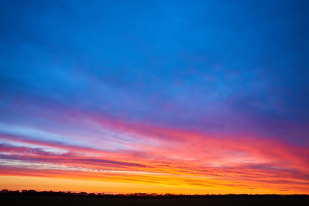Beautiful stormy sunset sky. Cloudy abstract background. Sunset colors.