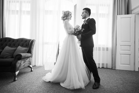Black and white photo of happy newly married couple dancingの写真素材