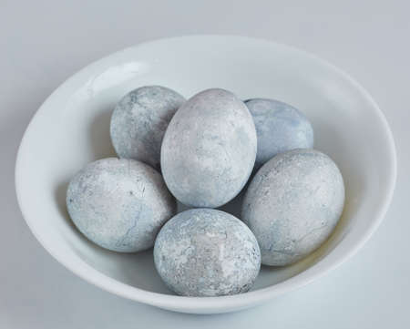 Eggs painted in blue and white are on a plate. Easter eggsの写真素材