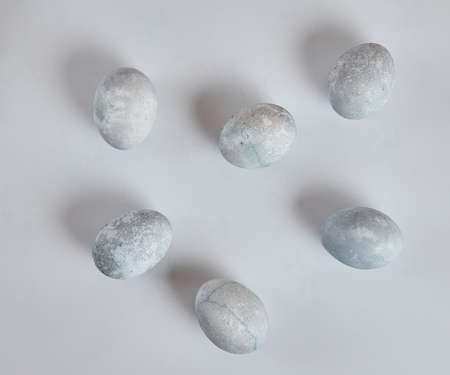 Painted eggs in blue and white lie on a white background. Easter eggsの写真素材