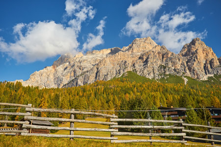 Stunning alpine Landscape at sautumn sunny day. Alpine meadow and road, mountains on background. amazing nature Landscape. Dolomites Alps. Italy. Amazing Nature background. travel concept.の写真素材