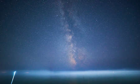 transverse milky way over the sea on the dark clear sky.の写真素材