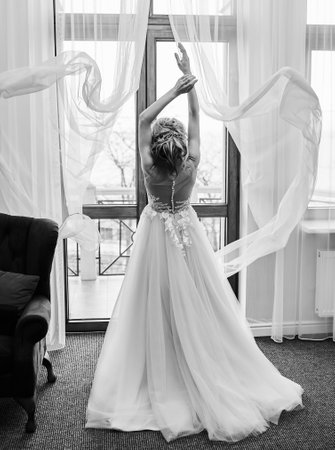 Morning of the bride. girl in a negligee. Glamorous photo session by the window.の写真素材