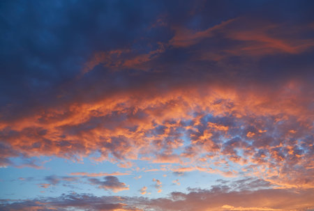 Cloudscape of cumulus sunset clouds with sunlight