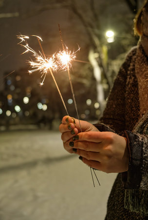 bright festive Christmas and happy new year sparkler in hand