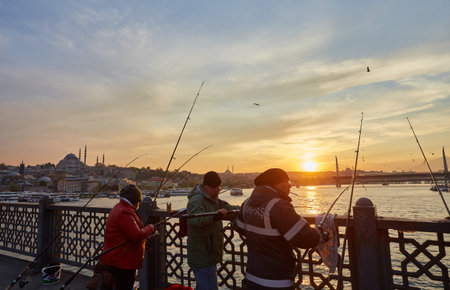 ISTANBUL, ISTANBUL - APRIL 21, 2017: Fishermen on Galata Bridge of Istanbul. Galata Bridge is a bridge that crosses the Golden Horn in Istanbul.のeditorial素材