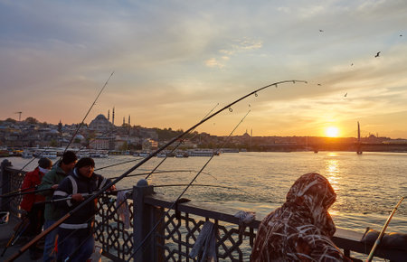 ISTANBUL, ISTANBUL - APRIL 21, 2017: Fishermen on Galata Bridge of Istanbul. Galata Bridge is a bridge that crosses the Golden Horn in Istanbul.のeditorial素材