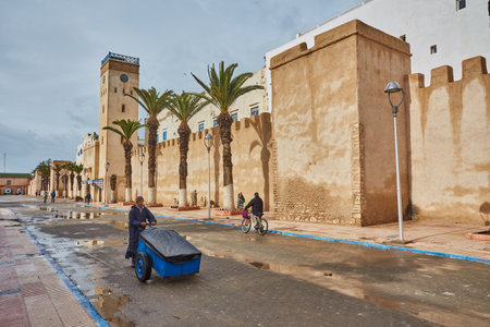 ESSAOUIRA, MOROCCO. 12 th February, 2017: Streets of the old city, Medina, colorful houses. People rushing to work, the city after the rainのeditorial素材