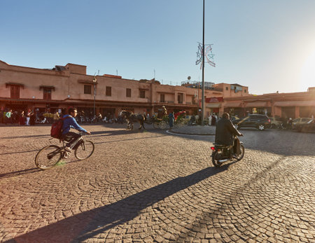 Morocco, Marrakech, February 02, 2017: Streets with traffic motorbike driving in market district and people walkingのeditorial素材