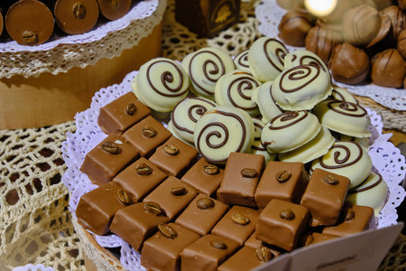 Assorted chocolate candies in a pastry shop, close-up. chocolate nuts candy balls and macaroons, sweets dessert foodの写真素材