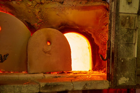glass blower at work. The glassblower blows a glass vase. glass manufactory production.の写真素材