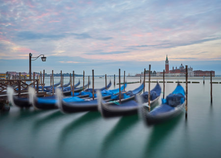 Gondolas at the St. Marks square in Venice, Italy, before a dramatic sunriseの写真素材