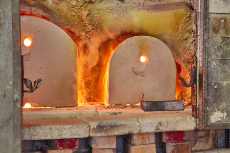 glass blower at work. The glassblower blows a glass vase. glass manufactory production.の写真素材
