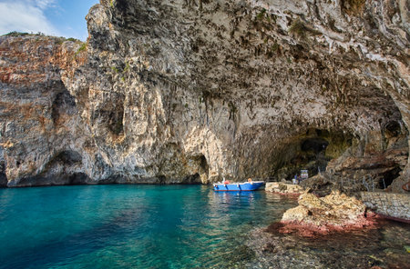 Grotta Zinzulusa. View from the cliff to the crystal clear azure Adriatic Sea with transparent water. gangway under the rocks to the cave. Salento region of Puglia Apulia, southern Italyの写真素材