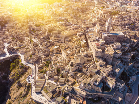Aerial view of medieval city of Matera Sassi di Matera in beautiful golden morning light at sunrise. Birds view of Sassi di Matera, in Basilicata, southern Italyの写真素材