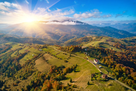 Aerial view of mountains at sunrise in autumn in Ukraine. Colorful landscape with mountain road,...