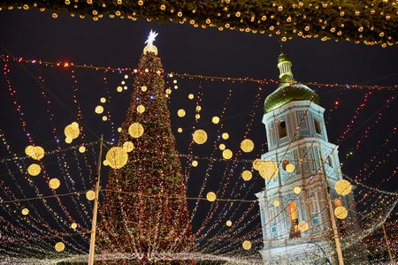Christmas tree with lights outdoors at night in Kiev. Sophia Cathedral on background. New Year Celebrationの写真素材