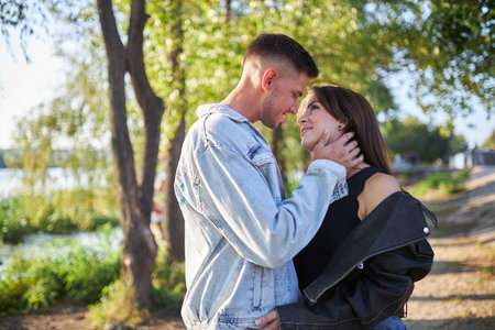Stylish and young man and woman posing on the street, a couple deeply in love.の写真素材