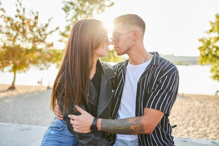 Stylish and young man and woman posing on the street, a couple deeply in love.の写真素材