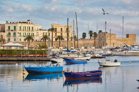 Bari town skyline and fishing boats - harbor in Apulia region, Italy.の写真素材