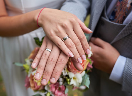 Bride and groom holding hands outdoors photoの写真素材