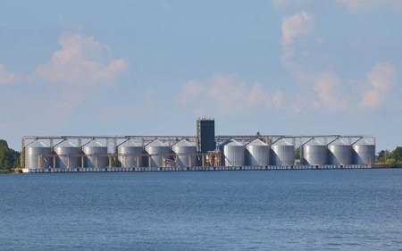 A grain elevator storage facility on a river, summer dayの写真素材
