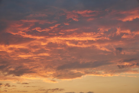 Cloudscape of cumulus sunset clouds with sunlightの写真素材