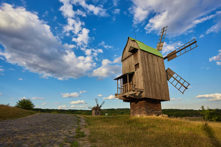 Old Ukrainian windmill under dramatic skies, Kiev, Ukraineの写真素材